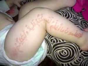 Who Writes Line From the Koran on a Body of the Baby?